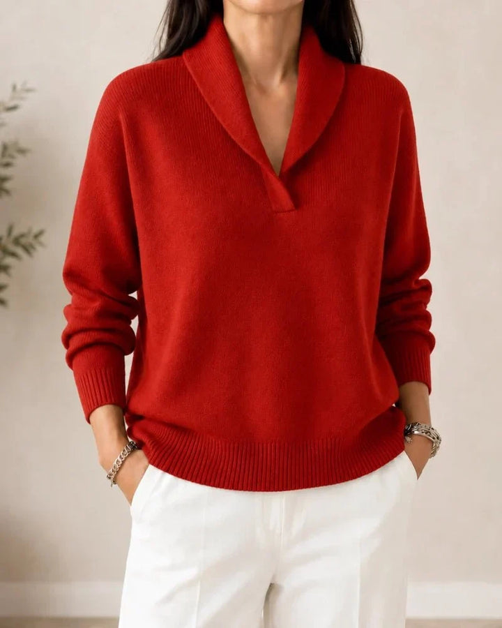 Front view of the sweater in bright red worn by a model with white trousers. 10