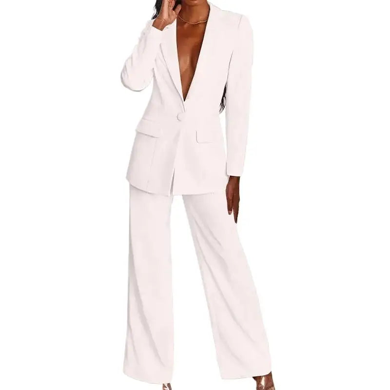 Cropped front view of the white blazer and wide-leg pants on a model with hand raised 2