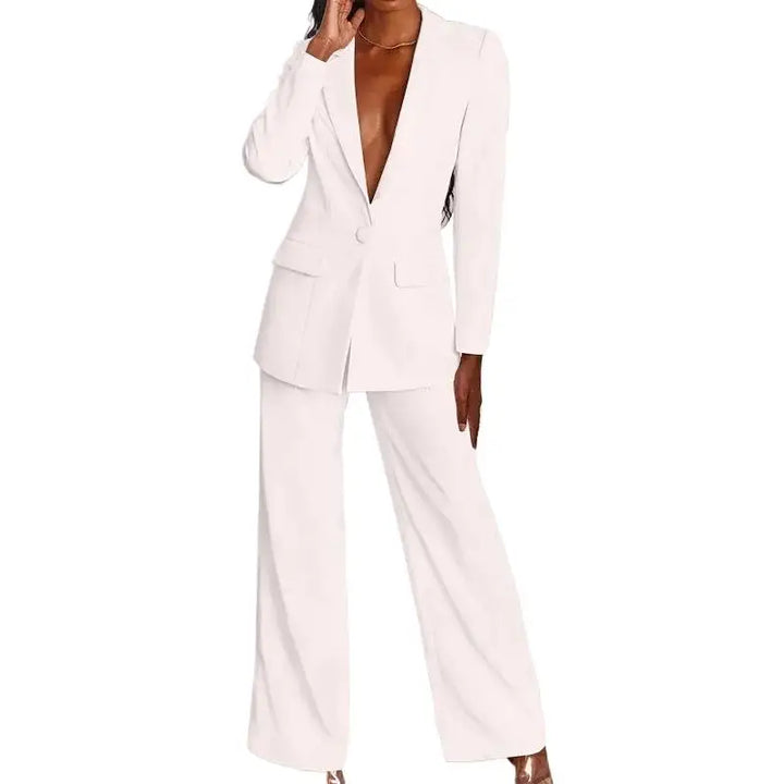 Cropped front view of the white blazer and wide-leg pants on a model with hand raised 2