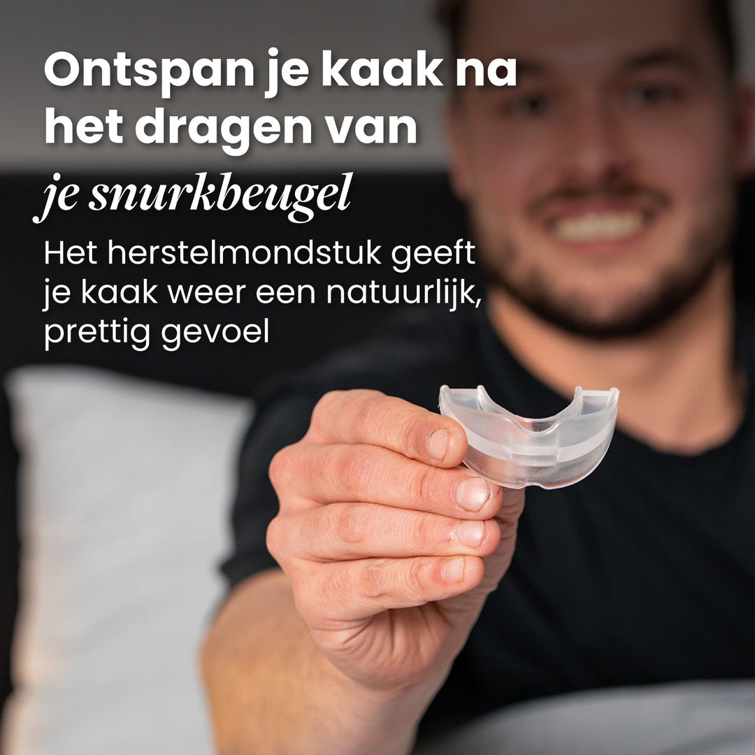 Smiling man holding the clear recovery mouthpiece toward the camera.