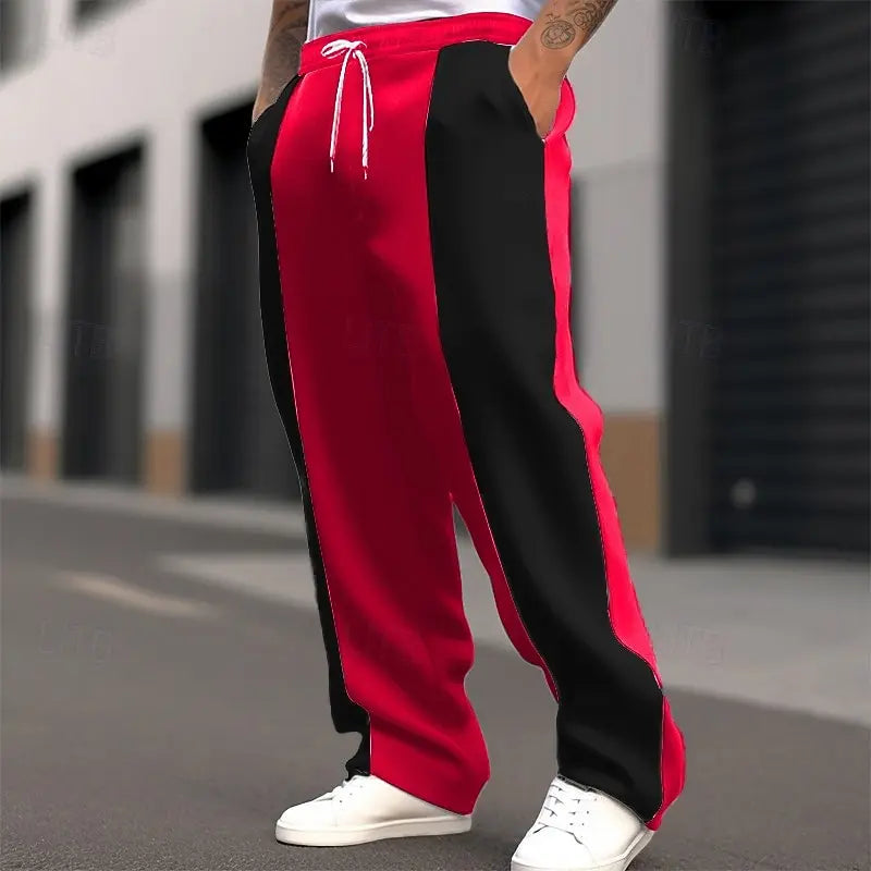 Cropped street shot of red and black color-block sweatpants with white drawstring and white sneakers 2