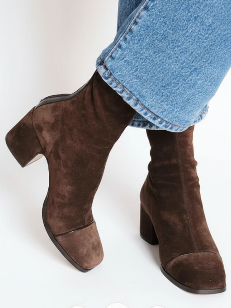 Brown leather heeled boots with cropped blue jeans, front and side view.