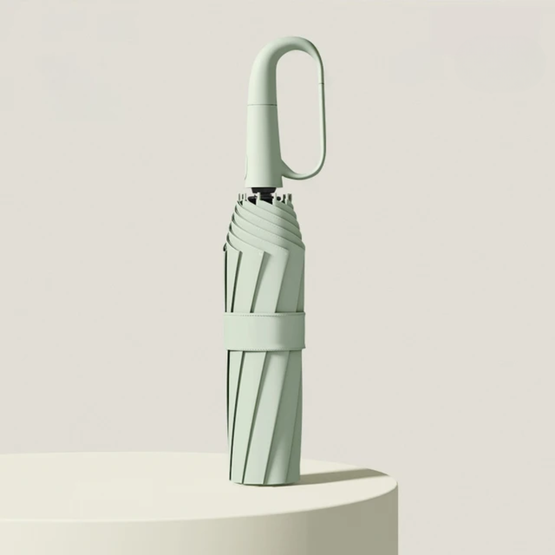 Closed folding umbrella in green with an oval hook handle and fabric strap.