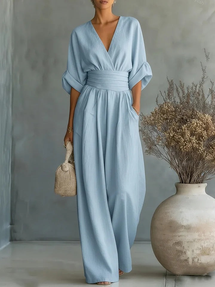 Light sky blue women's jumpsuit with a pleated waist and wide legs.