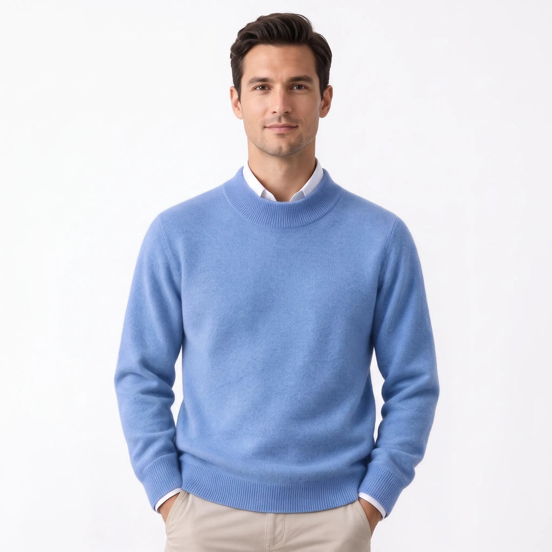 Man wearing the soft periwinkle blue sweater over a white collared shirt and khaki pants 30