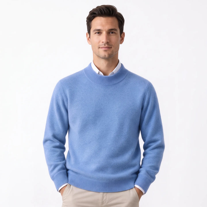 Man wearing the soft periwinkle blue sweater over a white collared shirt and khaki pants 30