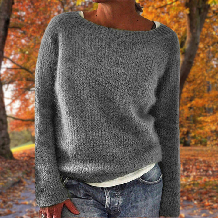 Gray ribbed knit sweater with a wide neckline, worn over a white tee and jeans outdoors 4