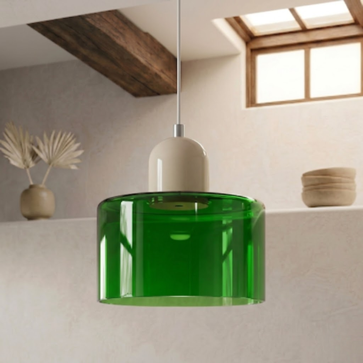 Translucent green glass shade with a cream dome cap hangs from a white cord against a plaster wall. 35