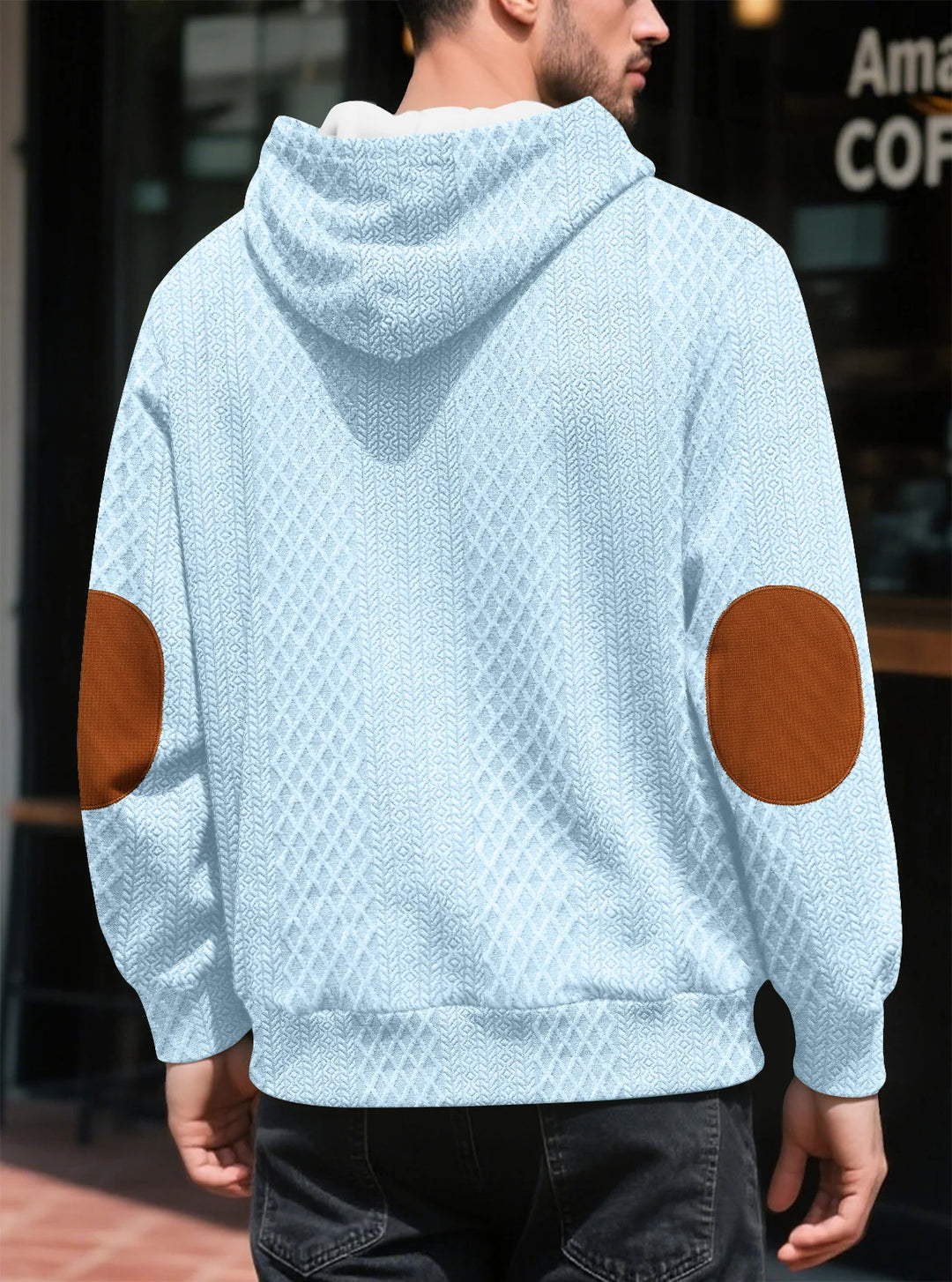 Back view of the light blue hoodie on a man, showing large brown elbow patches 30