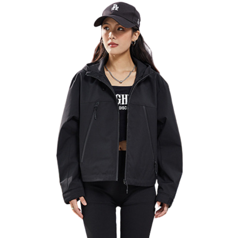 Black jacket worn open over a dark crop top with a necklace, front view showing the pocket zips and cuffs. 15