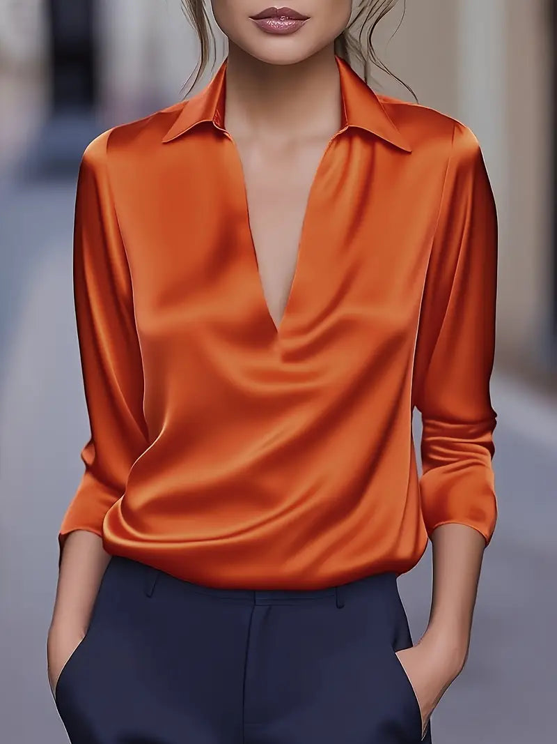 Model wearing the long-sleeve satin blouse in burnt orange with a deep V-neck and collar.
