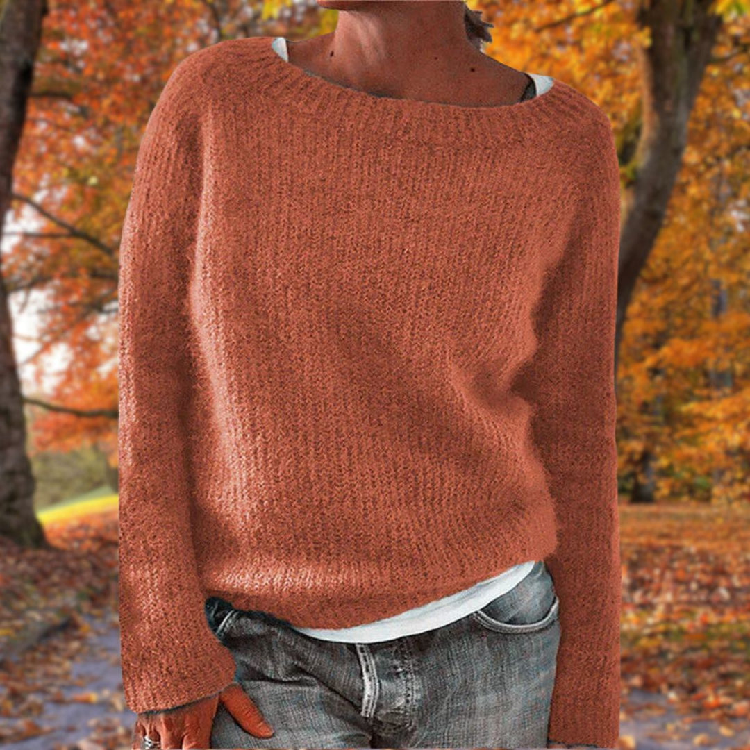 Rust orange knit sweater with a relaxed fit, worn over a white tee and gray jeans in autumn 6
