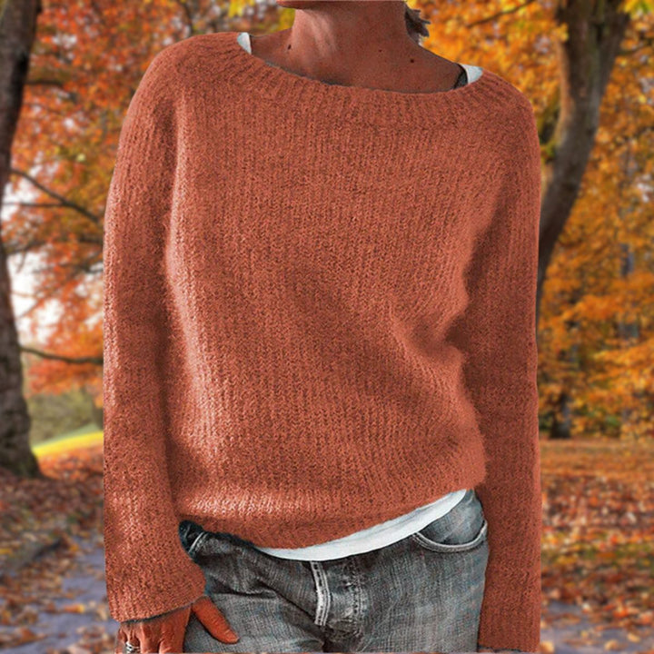 Rust orange knit sweater with a relaxed fit, worn over a white tee and gray jeans in autumn 6