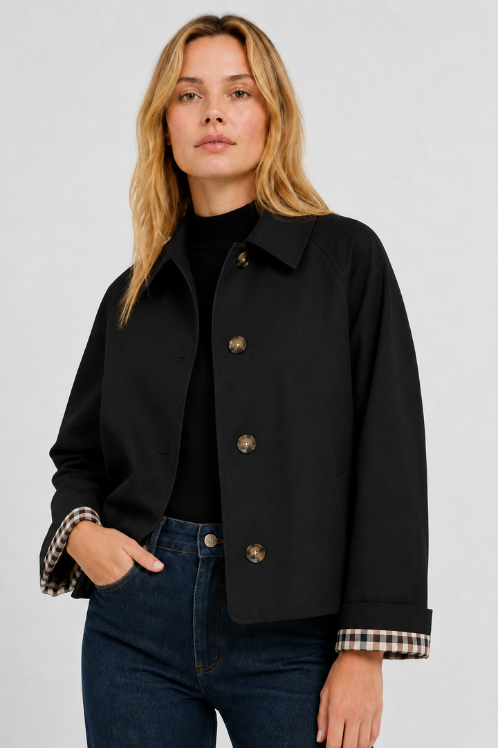 Women's black lightweight jacket with gingham cuff lining, front close-up.