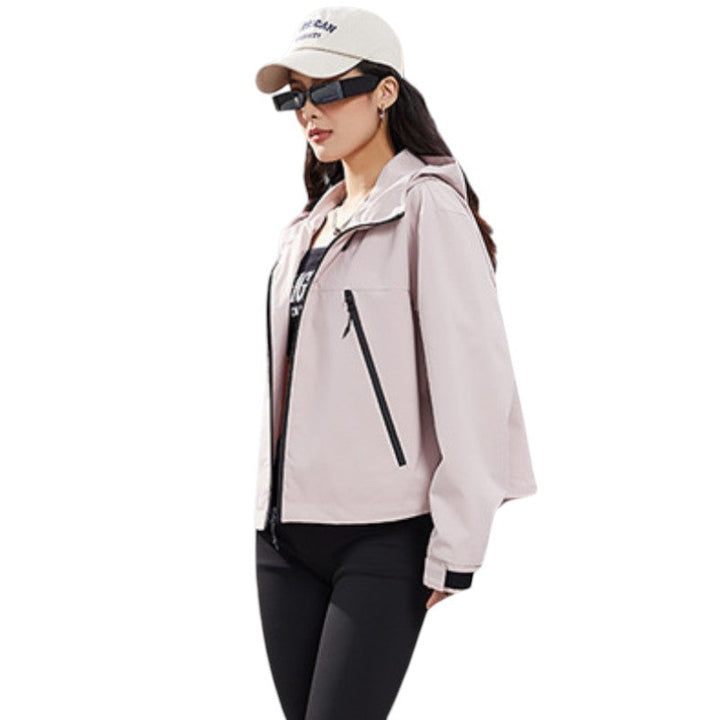 Three-quarter side view of the pink jacket worn open over a dark top, showing a diagonal black pocket zip. 11