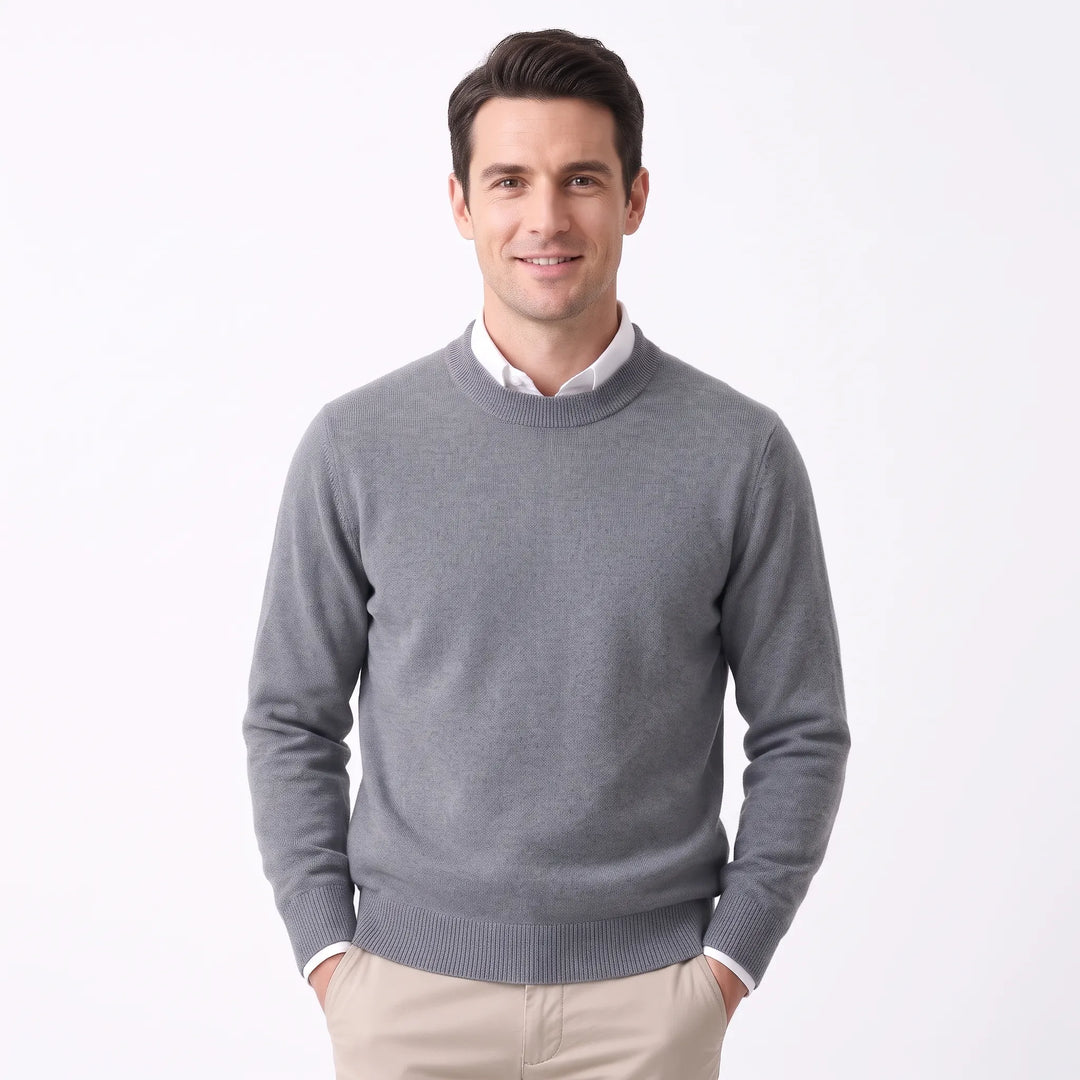 Smiling man wearing the medium gray sweater over a white collared shirt and khaki pants 35