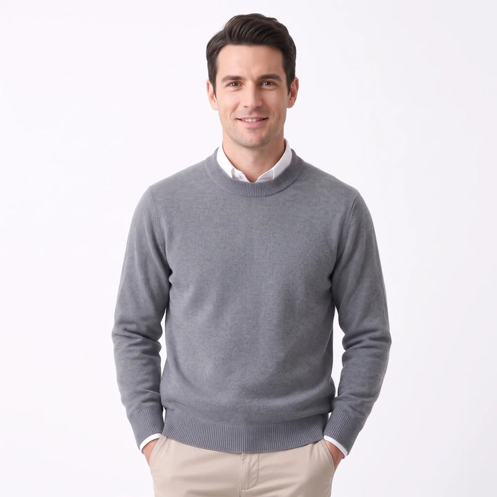 Smiling man wearing the medium gray sweater over a white collared shirt and khaki pants 35