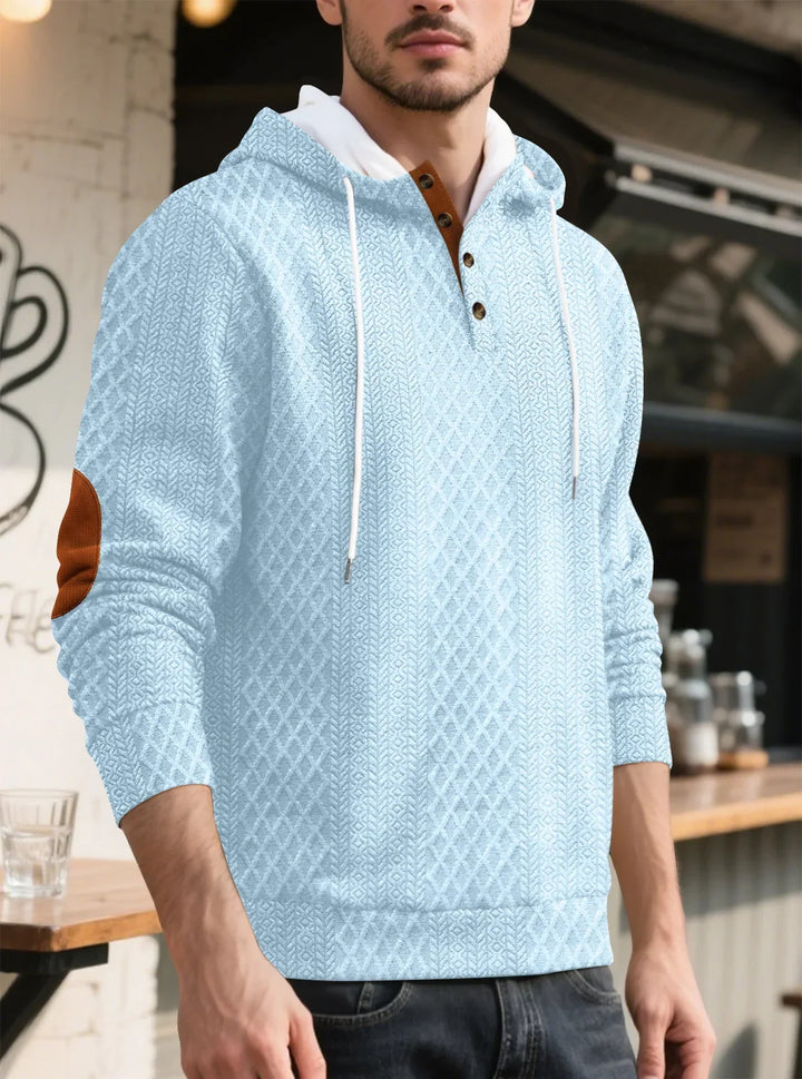 Angled view of the light blue textured hoodie worn by a man at a cafe counter 35