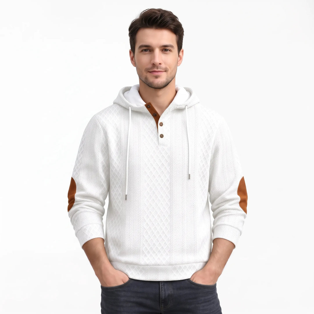 Studio shot of a man in the white textured hoodie with hands in pockets 38