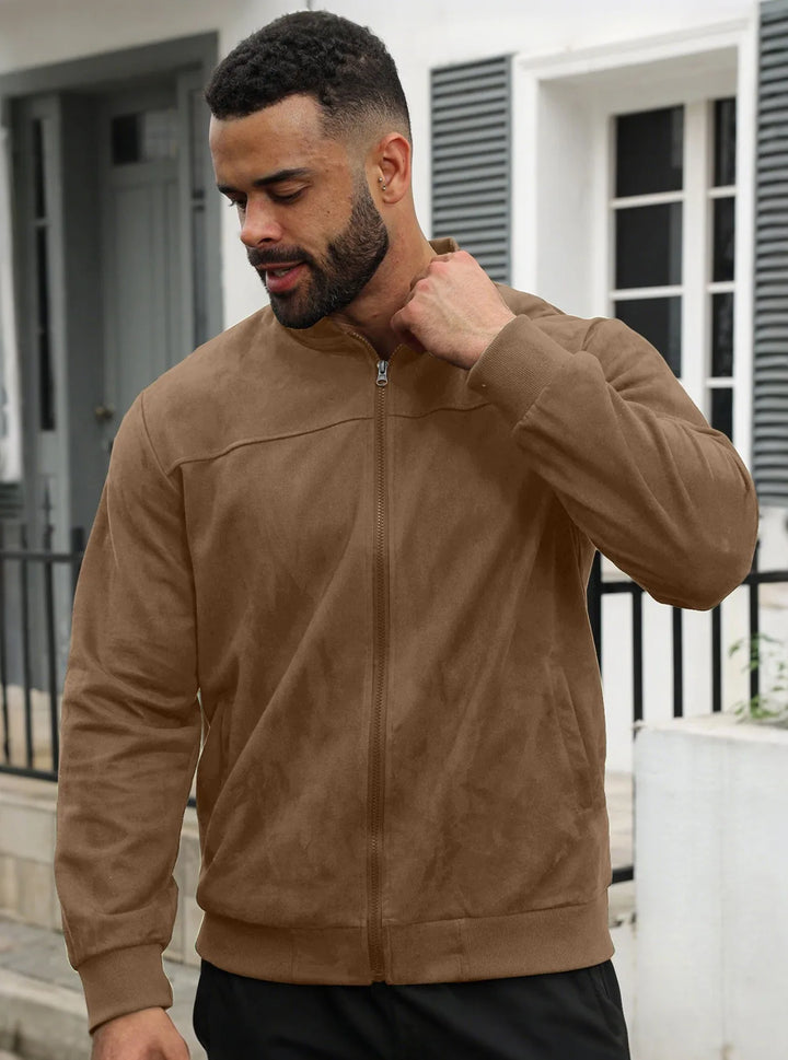 Man wearing brown suede-look zip-up jacket outdoors, front view, hand raised to his collar 38