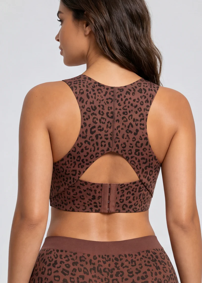 Back view of the leopard-print bra on a model, showing the keyhole cutout, center seam and hook closure.