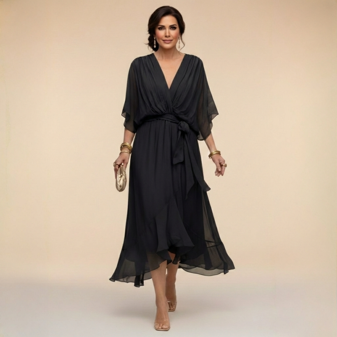 Black midi dress detail with a wrap-style V-neck and waist tie.