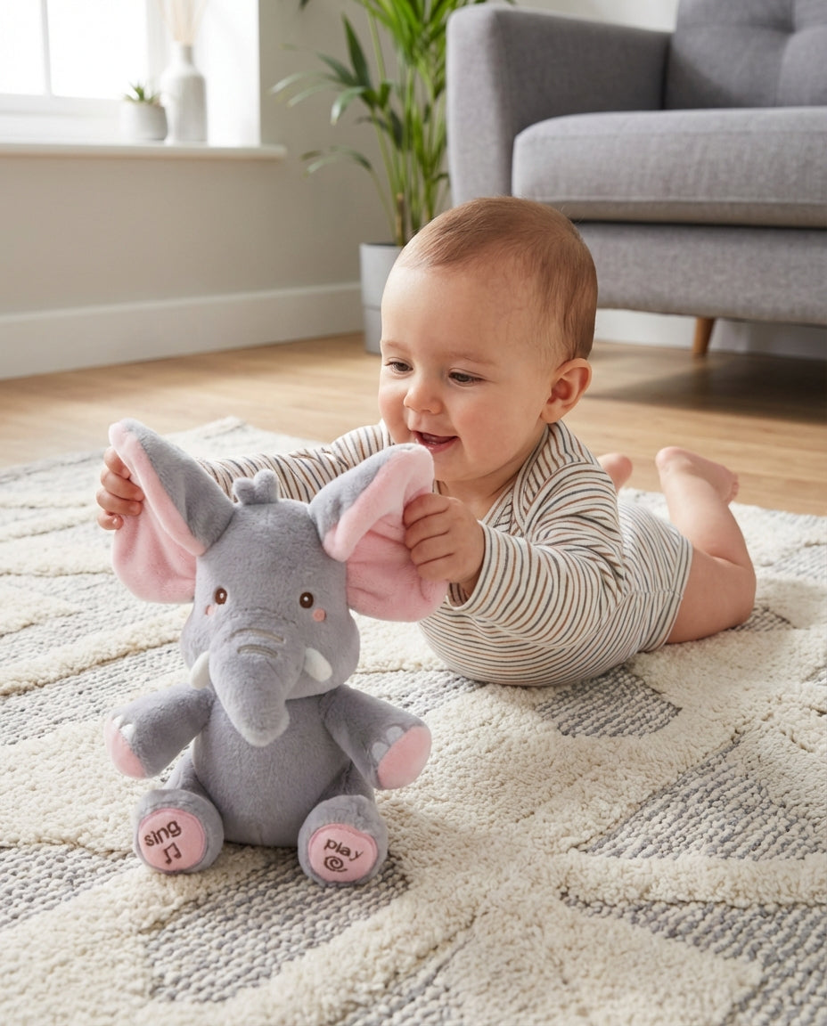 Another view of PeekaBuddy The Giggle Elephant Interactive Peekaboo Plush as a baby lifts its pink-lined ears.