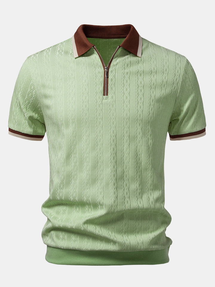 Light green polo with the quarter zip, brown contrast collar, striped sleeve cuffs, and cable-knit texture.