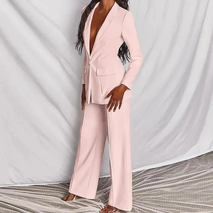 Three-quarter side view of the light pink suit against a draped backdrop 3