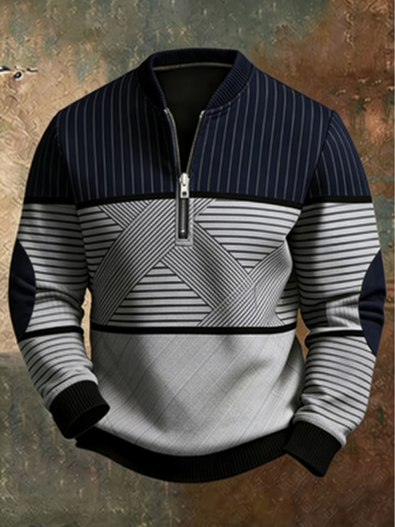 Men's striped half-zip sweater in navy and light gray with geometric crisscross stripes and black ribbed cuffs and hem.