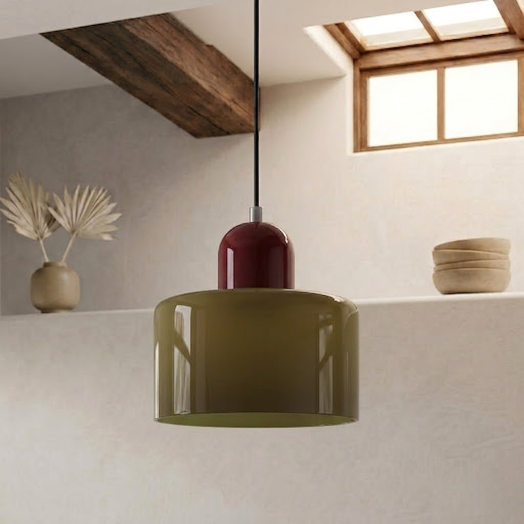 Olive green drum shade with a deep burgundy cap, hanging from a black cord in a warm plaster-walled space. 9