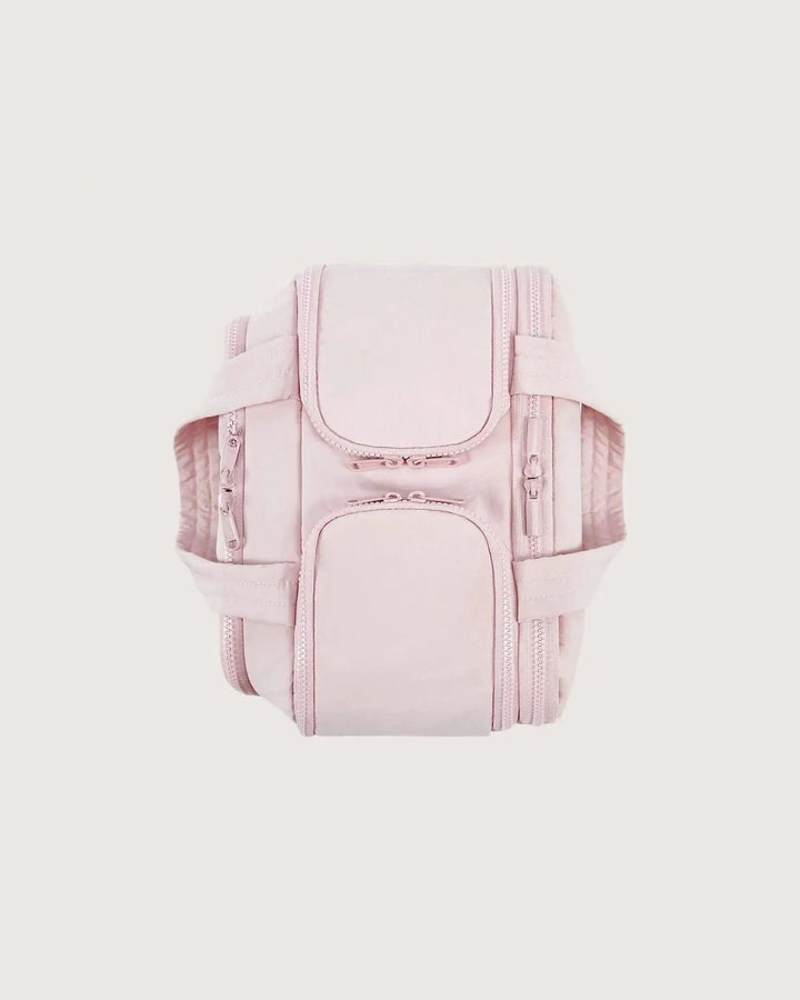 Pink bag seen from above with handles folded flat, showing the zippered pockets on top and both sides.