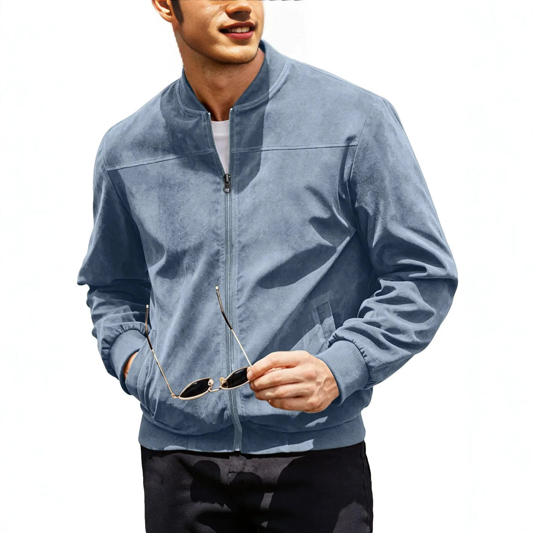 Torso of a model in a light blue zip-up jacket holding sunglasses, one hand in pocket 3