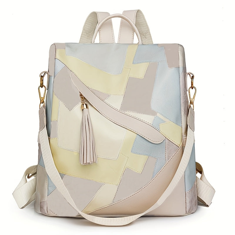 Cream patchwork backpack in pale yellow, light blue and beige panels, with a tassel, gold clasps and a long strap. 10