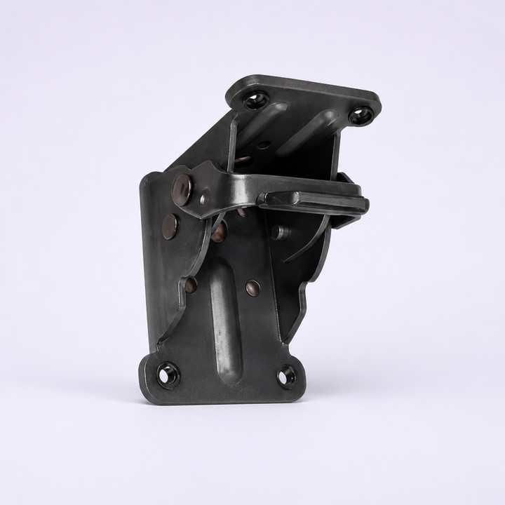 Dark gunmetal folding bracket on a plain light background with riveted plates, slotted ridge, release lever and screw holes.