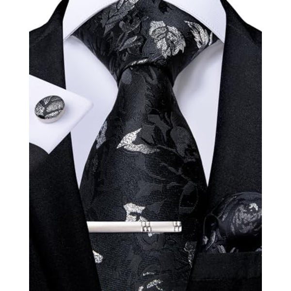 Black floral tie set with silver leaf motifs, paired with a matching cufflink, pocket square and silver tie clip.