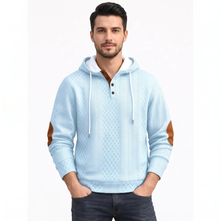 Man wearing light blue diamond-textured hoodie with white hood lining, brown button placket and brown elbow patches 42