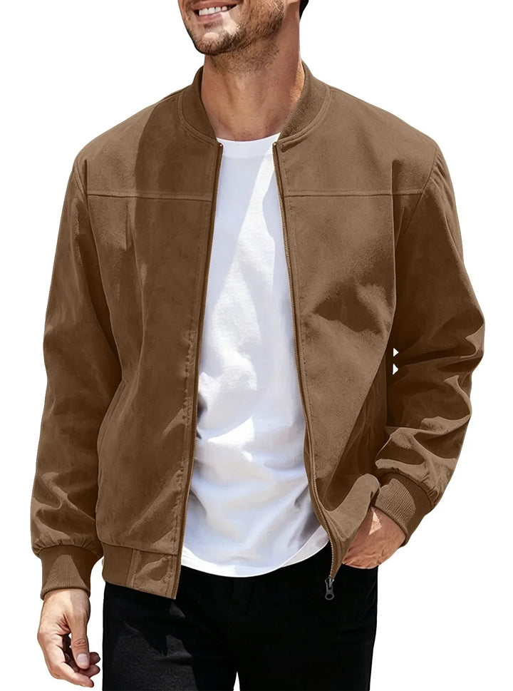 Man wearing the brown zip-up bomber open over a white tee, hand in pocket 45