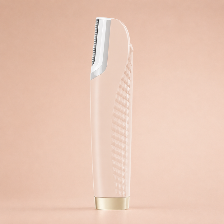 Pale blush-pink version of the hair remover seen from the side, with textured grip, white blade head and gold base.