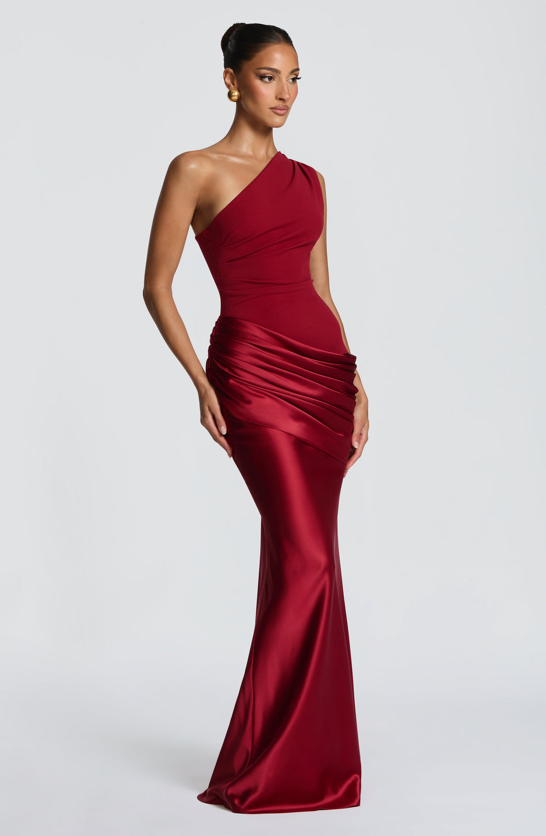 Deep red gown at a three-quarter angle, showing the fitted bodice and fluted satin skirt. 16