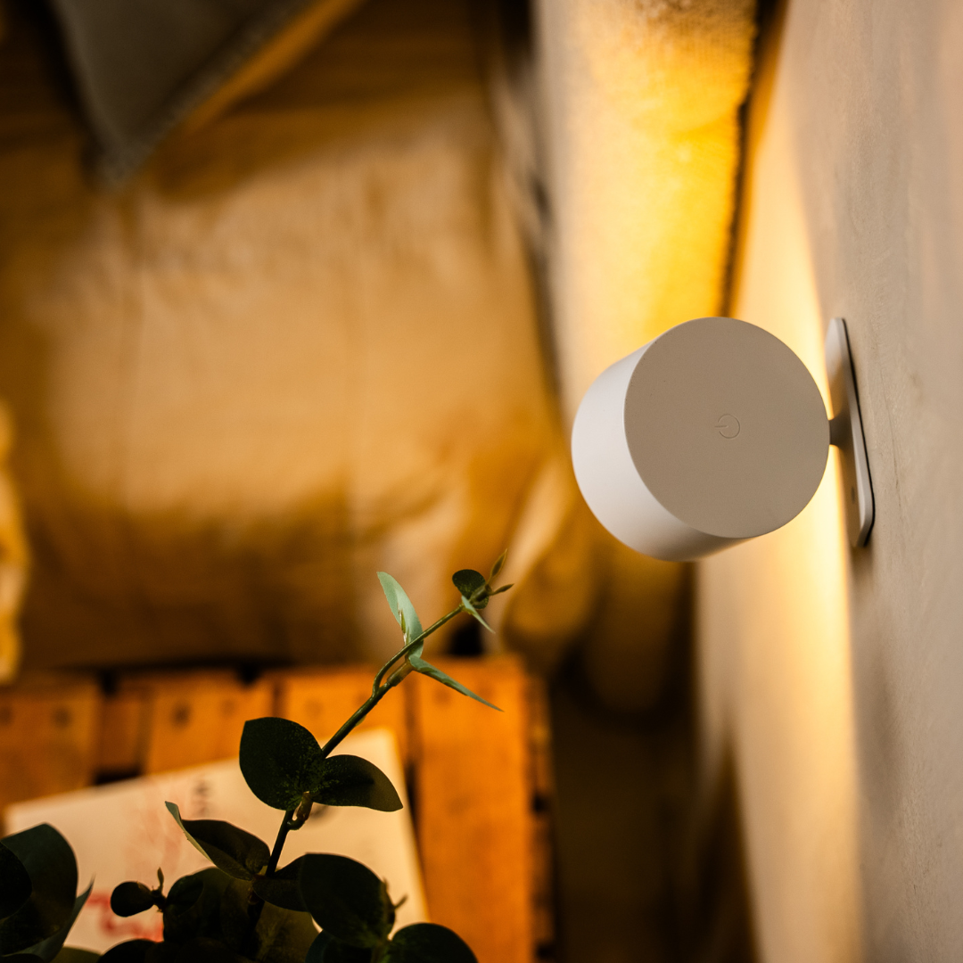 Rear view of the black wireless LED wall light showing the back disc and touch-control icon.