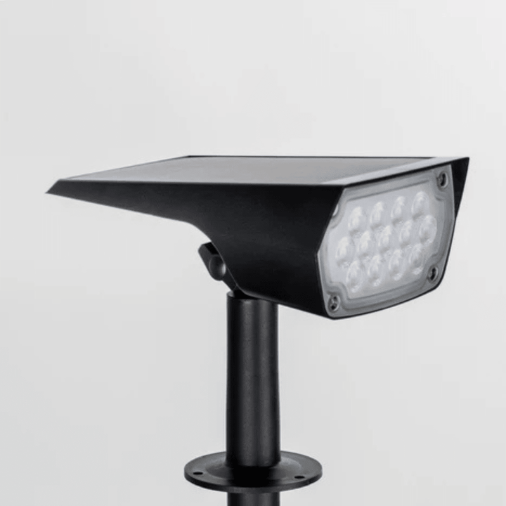 Front view of the black solar light head with its LED panel and solar panel on top.