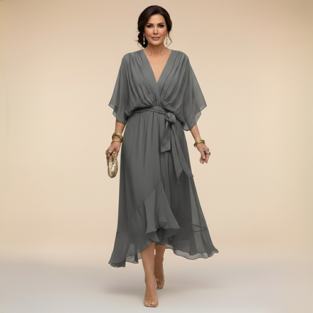 Charcoal gray midi dress detail with a V-neck, belted waist and asymmetric ruffled hemline.