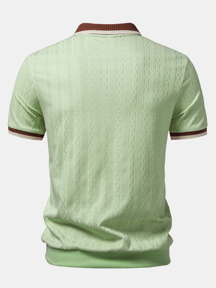 Light green textured knit polo from the back with the cable pattern, striped collar edge, cuffs, and matching ribbed hem.