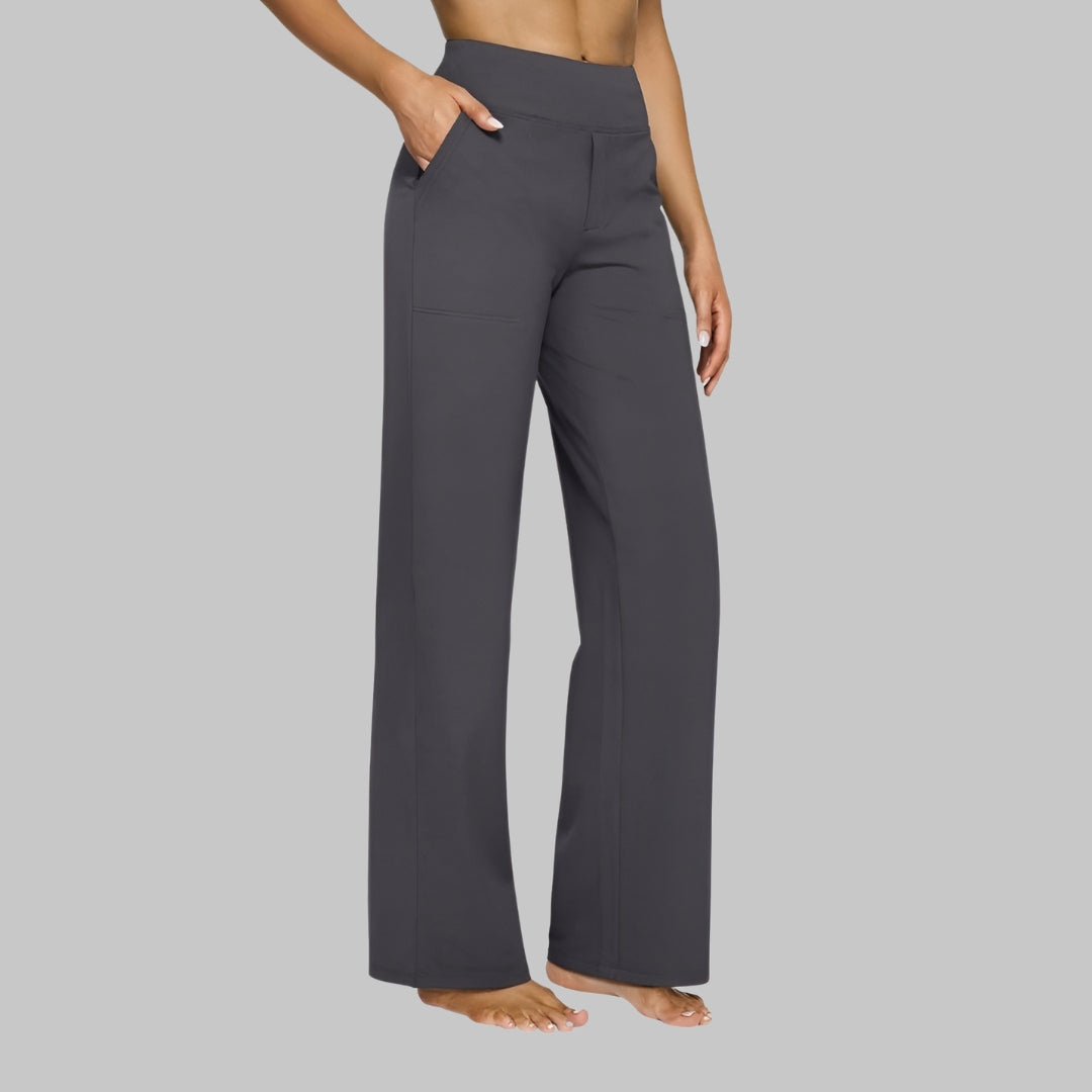Women's dark charcoal gray high-waist straight-leg pants on a model, side view with one hand in the pocket.