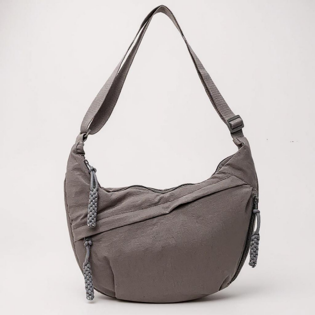 Gray nylon shoulder bag with adjustable strap and braided zipper pulls, detail.