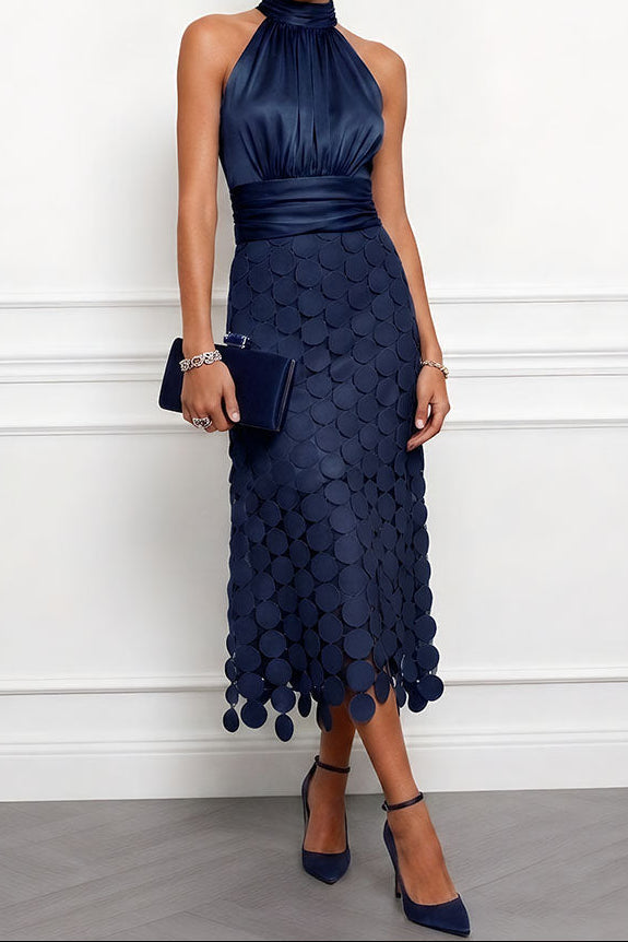 Halter Satin Midi Occasion Dress with Appliqué Skirt in navy blue with a dark velvet-look clutch and navy pointed ankle-strap heels.