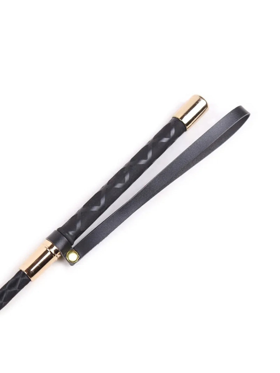 Close-up of the handle end showing gold-tone caps, textured black grip and a thin wrist loop with a snap 3