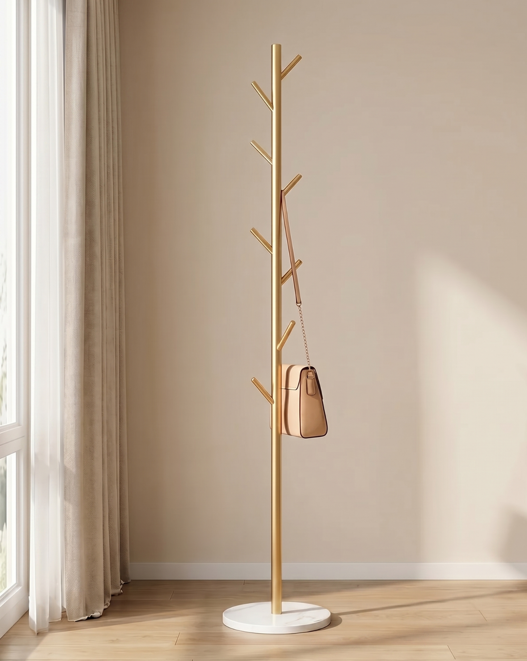 Gold-finish version of the rack on a white round base, with a tan handbag hanging from a hook 4