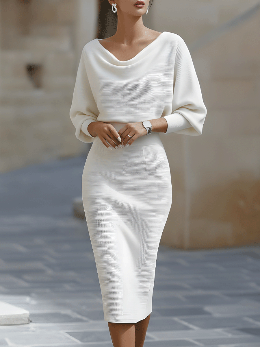 Model in the white version of the ribbed fitted midi dress, front view outdoors 2
